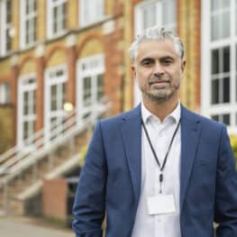 School principal standing outdoors on campus