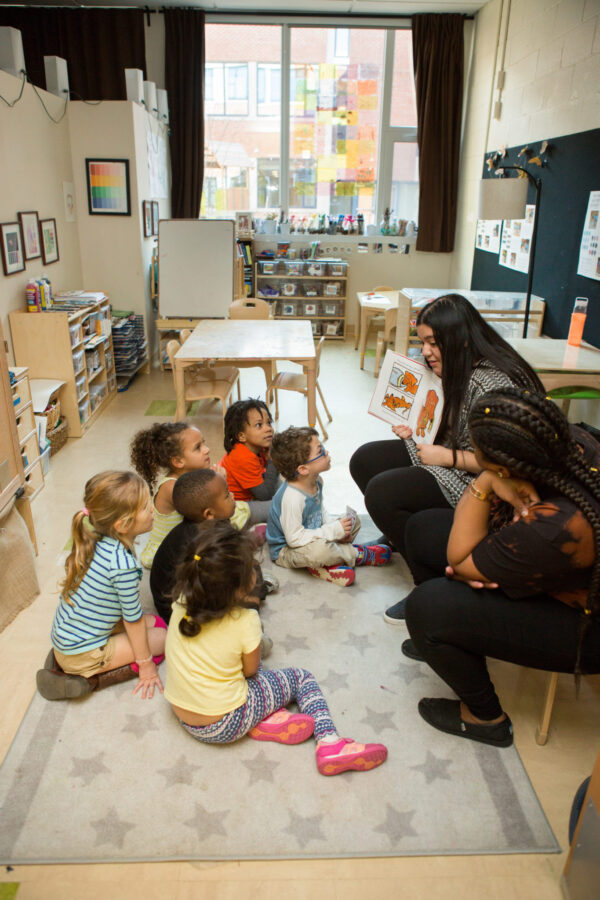 High schoolers from a Teaching 101 class practice their teaching skills with preschool students.