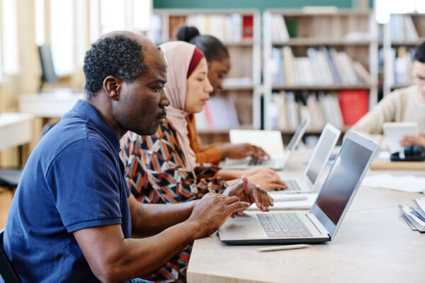 Adults using laptops