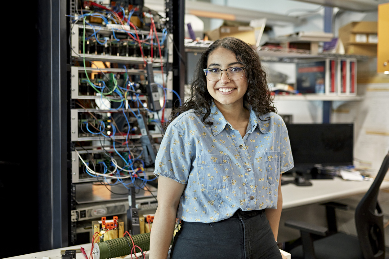 Career Connected Learning, young woman in front of server cords